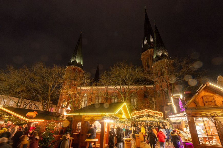 Blick über den Rathausmarkt mit beleuchteter Lamberti-Kirche beim Lamberti-Markt 2023. Foto: Sascha Stüber