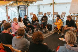 Menschen sitzen in einem Pavillon im Kreis. Foto: Florian Skupin 