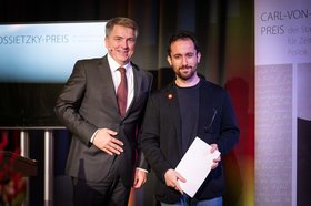 Oberbürgermeister Krogmann und Igor Levit (mit Urkunde). Foto: Mohssen Assanimoghaddam