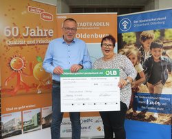 Günter Walter, Geschäftsführer der aktiv und irma Verbrauchermarkt GmbH, überreicht den Scheck für das Erreichen des Etappenziels an Monika Kreye, Geschäftsführerin Kinderschutzbund Deutschland Ortsverband Oldenburg e.V. Foto: Stadt Oldenburg