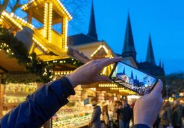 Blick durch ein Handy in Richtung Lamberti-Kirche. Foto: Sascha Stüber