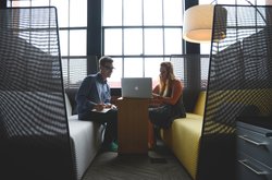 Two businessmen in front of a laptop. Photo: StartupStockPhotos/Pixabay