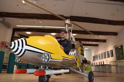 Projektleiter Bernd Hubl und die „UK Begegnungen“ sind startklar. „Little Nellie“, ein Nachbau des legendären James-Bond-Hubschraubers, ist als Blickfang für eine Ausstellung über die Filmwelten von „007“ im Schlauen Haus gelandet. Foto: Stadt Oldenburg