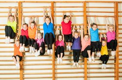 Kinder hängen an Turnstangen. Foto: Shmel/AdobeStock