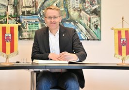 Ministerpräsident Daniel Günther trägt sich ins Goldene Buch ein. Foto: Sascha Stüber