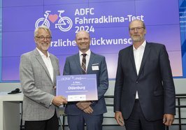 Thomas Mehrtens (Mitte) erhielt den Preis aus den Händen des ADFC-Bundesvorsitzenden Frank Masurat (links) und mit Glückwünschen von Ludger Molitor (Unterabteilungsleiter im Bundesverkehrsministerium). Foto: ADFC/Dirk Deckbar
