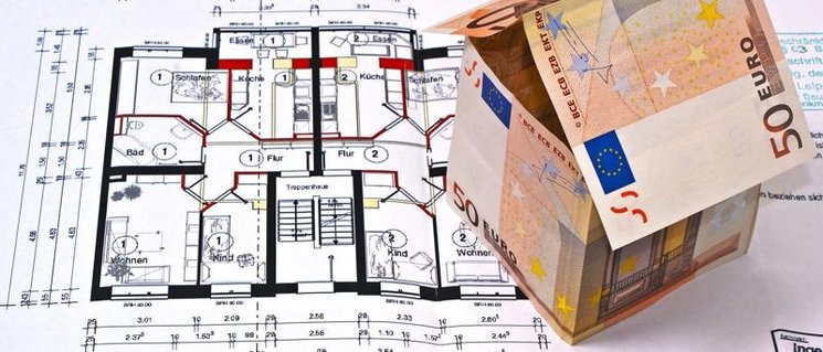 Ein Haus aus Geldscheinen steht auf einem Bauplan. Foto: Grabscheit/Pixelio.de
