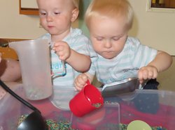 Zwei Kleinkinder spielen mit farbigem Reis. Foto: Stadt Oldenburg Zwei Kleinkinder spielen mit farbigem Reis. Foto: Stadt Oldenburg