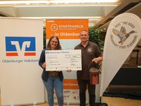 Franziska Rudolphi, stellvertretende Marktbereichsleiterin Oldenburger Volksbank eG, überreicht den Scheck für das sechste Etappenziel an Christian Brummer, Leiter Hegering Nord. Foto: Stadt Oldenburg Franziska Rudolphi, stellvertretende Marktbereichsleiterin Oldenburger Volksbank eG, überreicht den Scheck für das sechste Etappenziel an Christian Brummer, Leiter Hegering Nord. Foto: Stadt Oldenburg