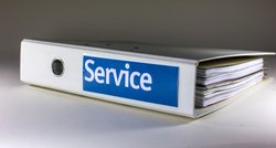 Weißer Ordner liegt auf der Seite. Auf blauem Aufkleber steht „Service“. Foto: Rainer Sturm/Pixelio.de