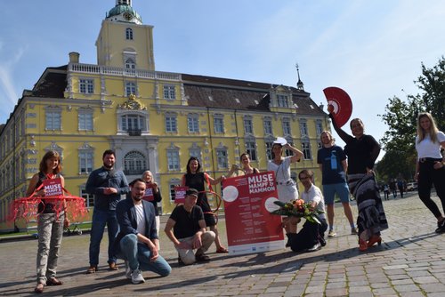 Werben für „Muse, Mampf & Mammon“: (von links) Ina Lehnert-Jenisch (Wirtschaftsförderung), Martin Mierzejewski und Eike Redlin (Büro + Raumkultur Schumacher), Marion Meister (cre8), Schauspieler Jo Schmitt, Katja Reiche (cre8), Verena Dzur (Deeper Connection Cards), Katharina Semling (cre8), Stefan Mühlhaus (Polyester Klub), Frederic Prellwitz (Buddeljungs), Flamenco-Tänzerin Flavie Cardona sowie Yasemine Limberg (Combi City). Foto: Stadt Oldenburg