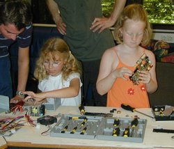 Zwei Mädchen basteln an Computerteilen. Quelle: Physik für Kids